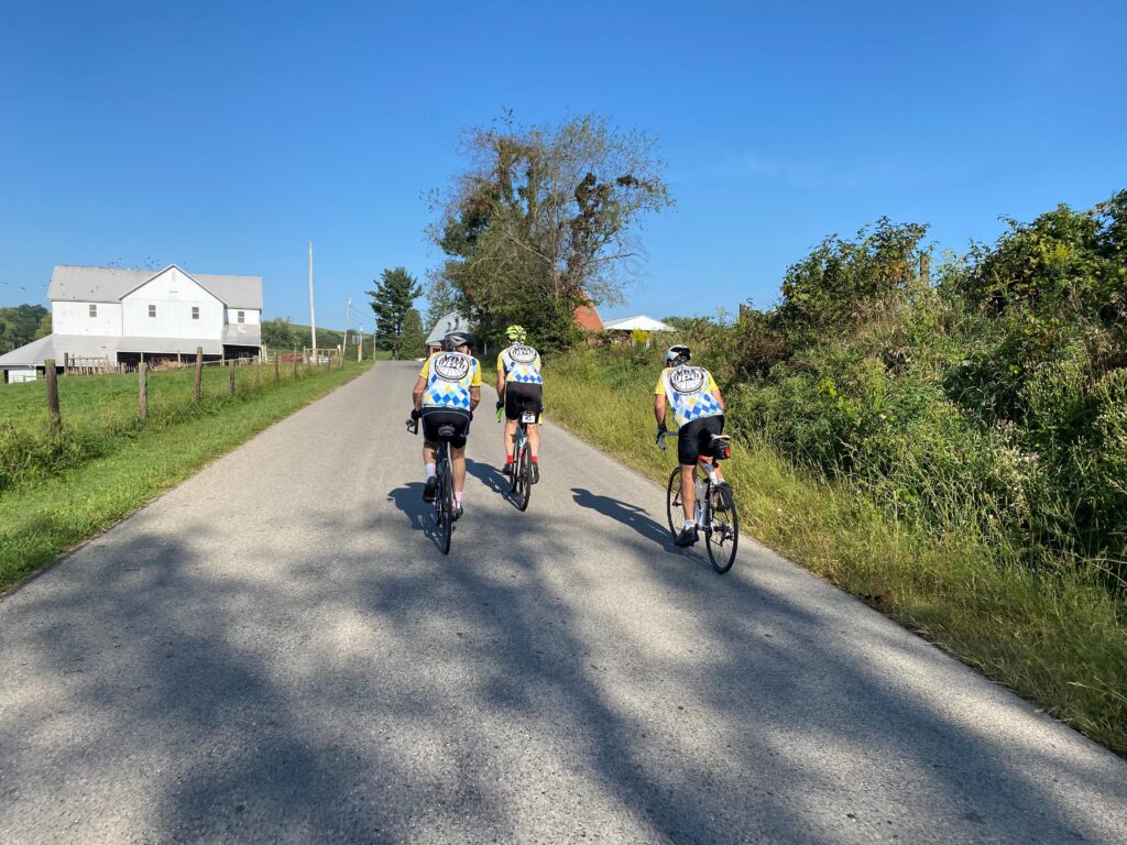 Three club cyclists ridng on a country road